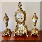 D27. 3-Piece garniture set with clock. Handpainted porcelain panels. Electric clock need repair. - $150 